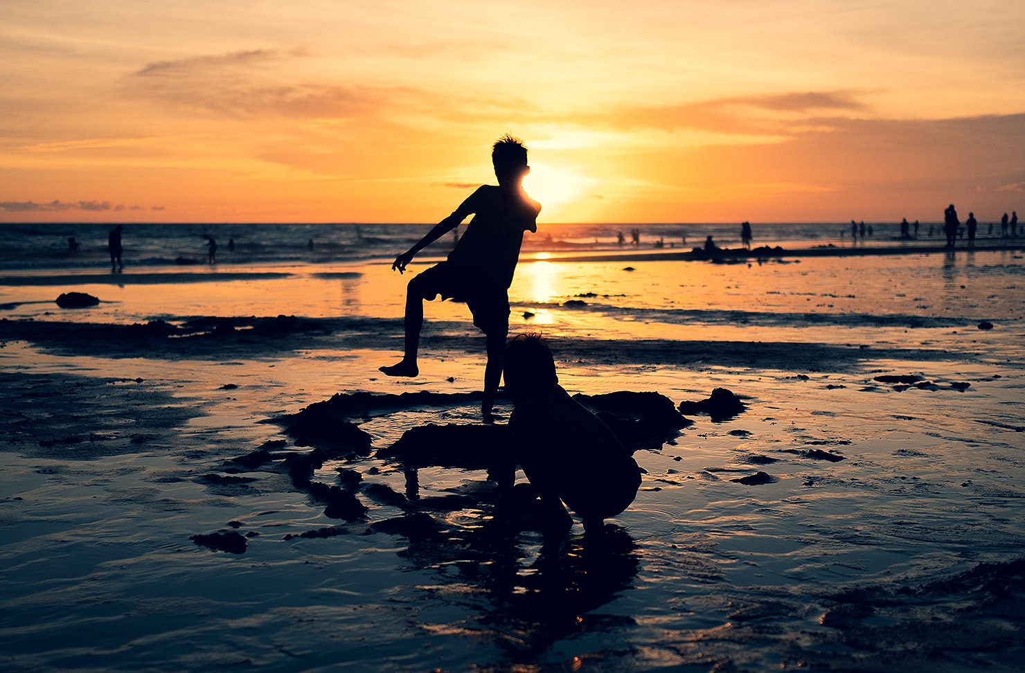 Kids splash about at sunset